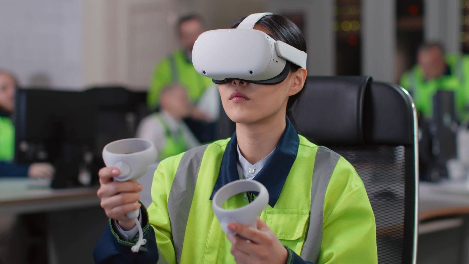 a woman wearing virtual reality goggles and a high-visibility vest