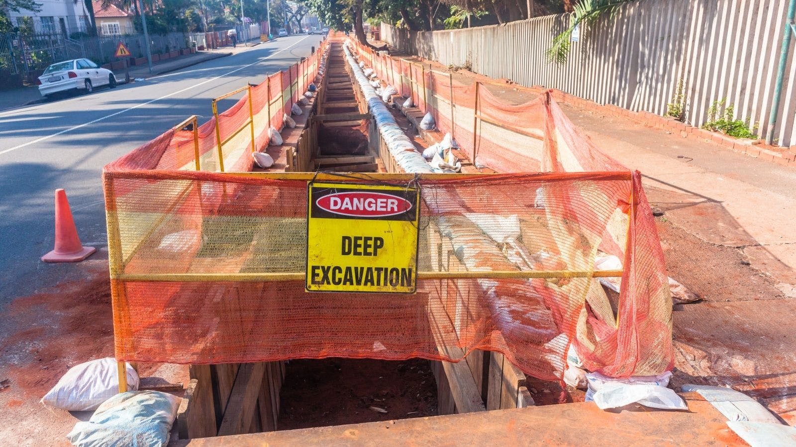 an excavation trench with a danger sign 