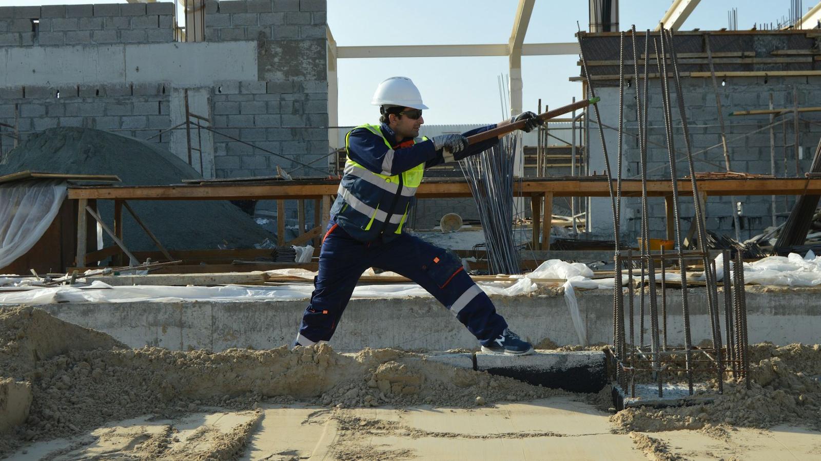 a construction worker bending rebar on a jobsite