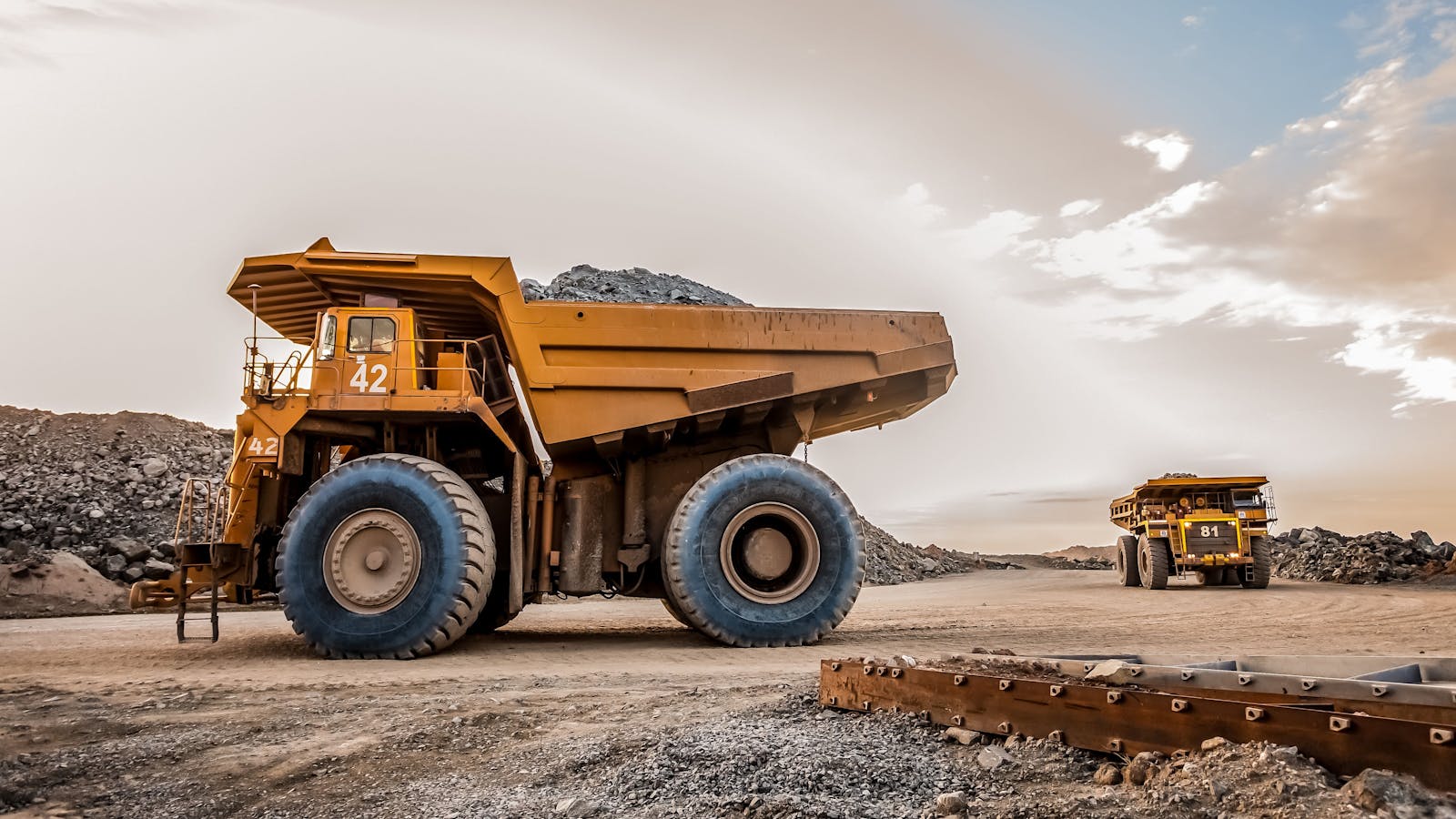 an oversized construction dumpster vehicle on a rocky jobsite