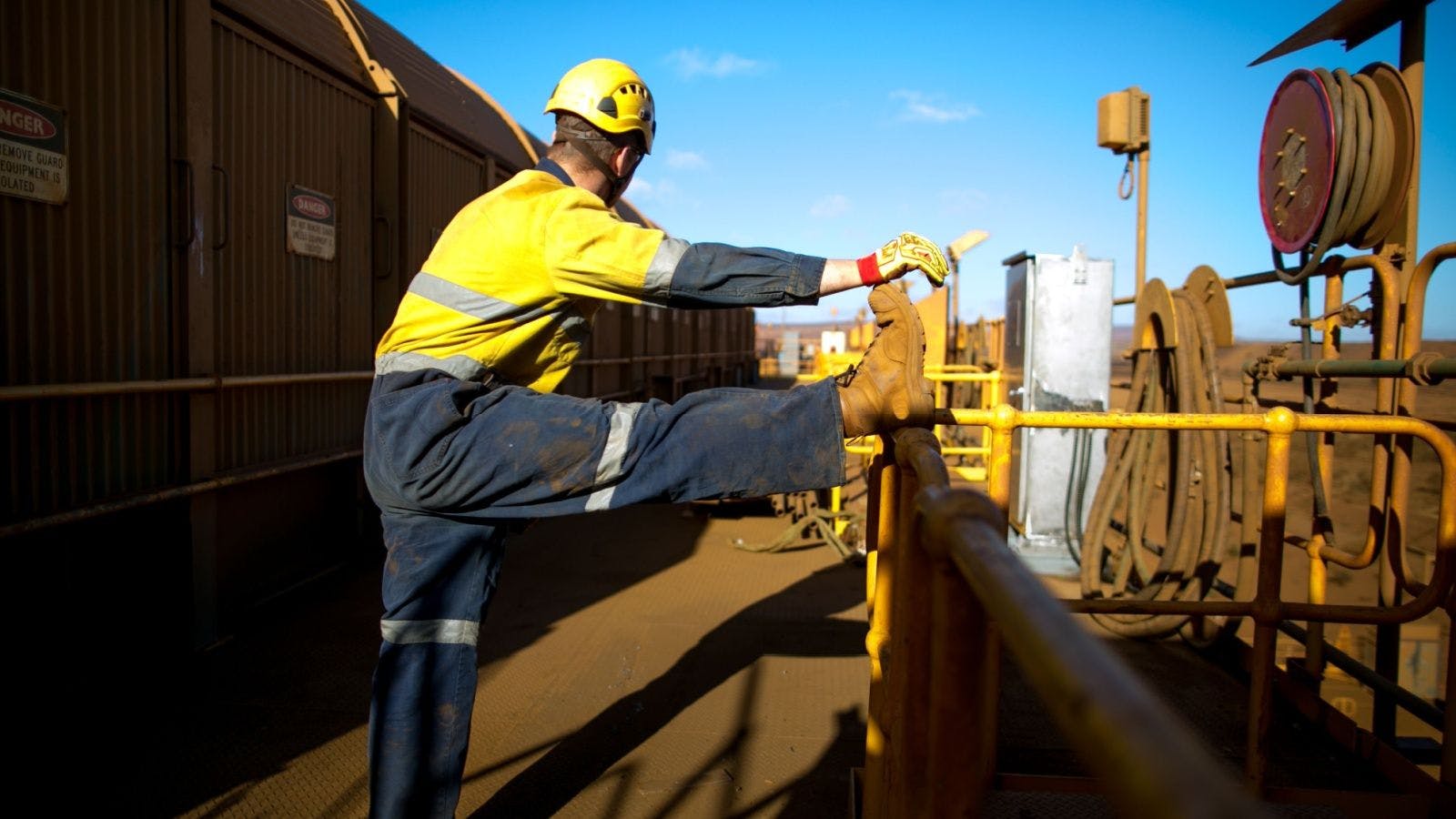 a construction worker stretching on the jobsite