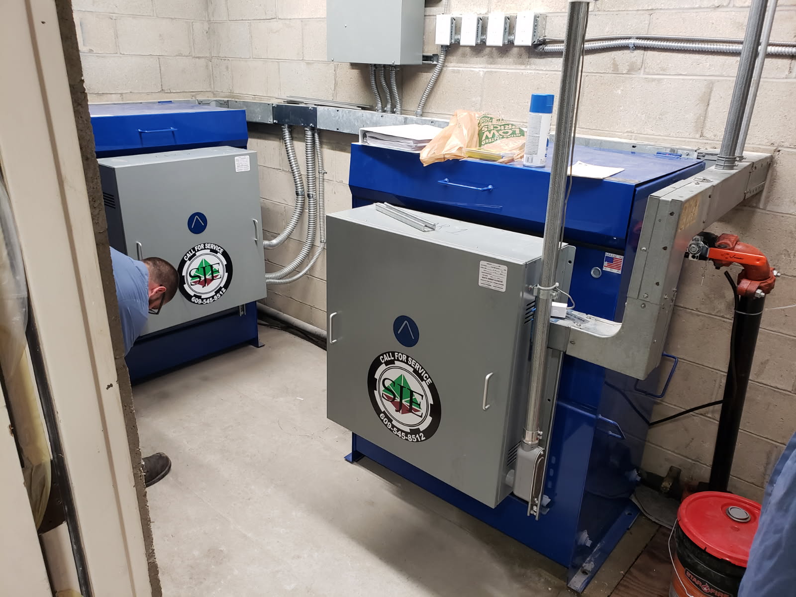 A technician completes installation of new hydraulic elevator equipment, which is powered by pistons rather than the steel ropes or belts used in a traction elevator