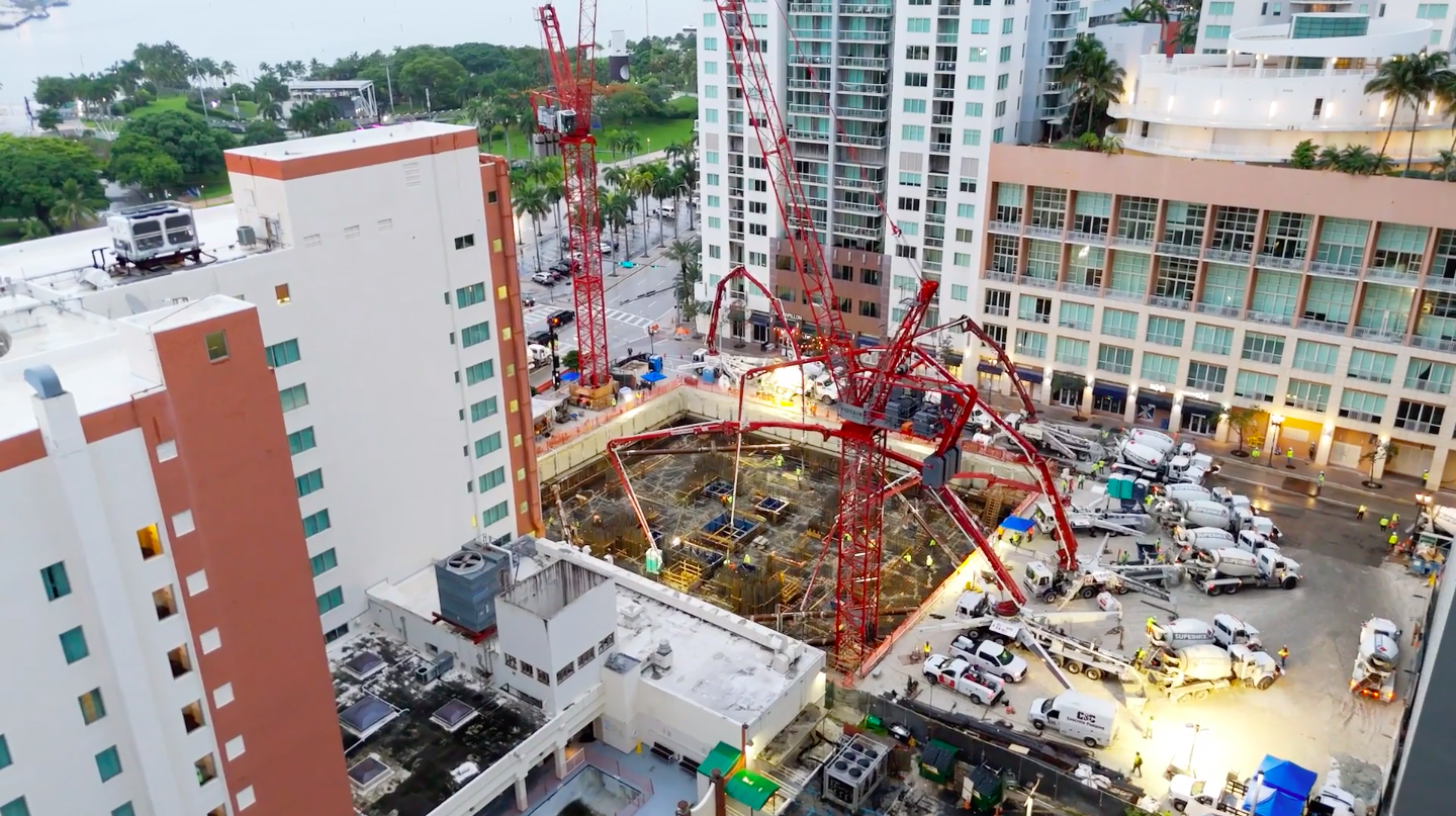 several cranes erected over the concrete foundation at the new Waldorf Astoria in Miami