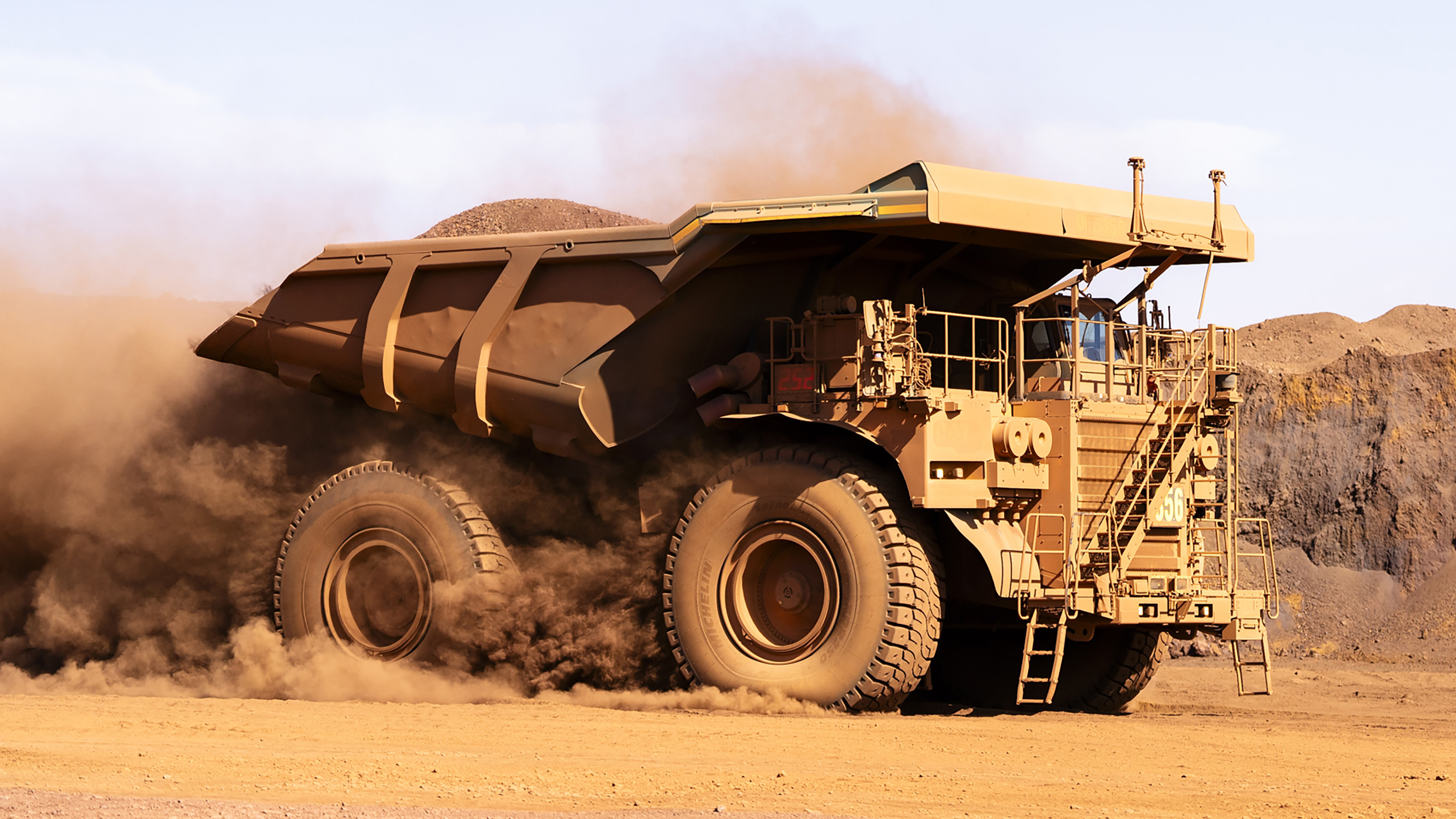 a large dump truck carrying dirt in the Jordan desert