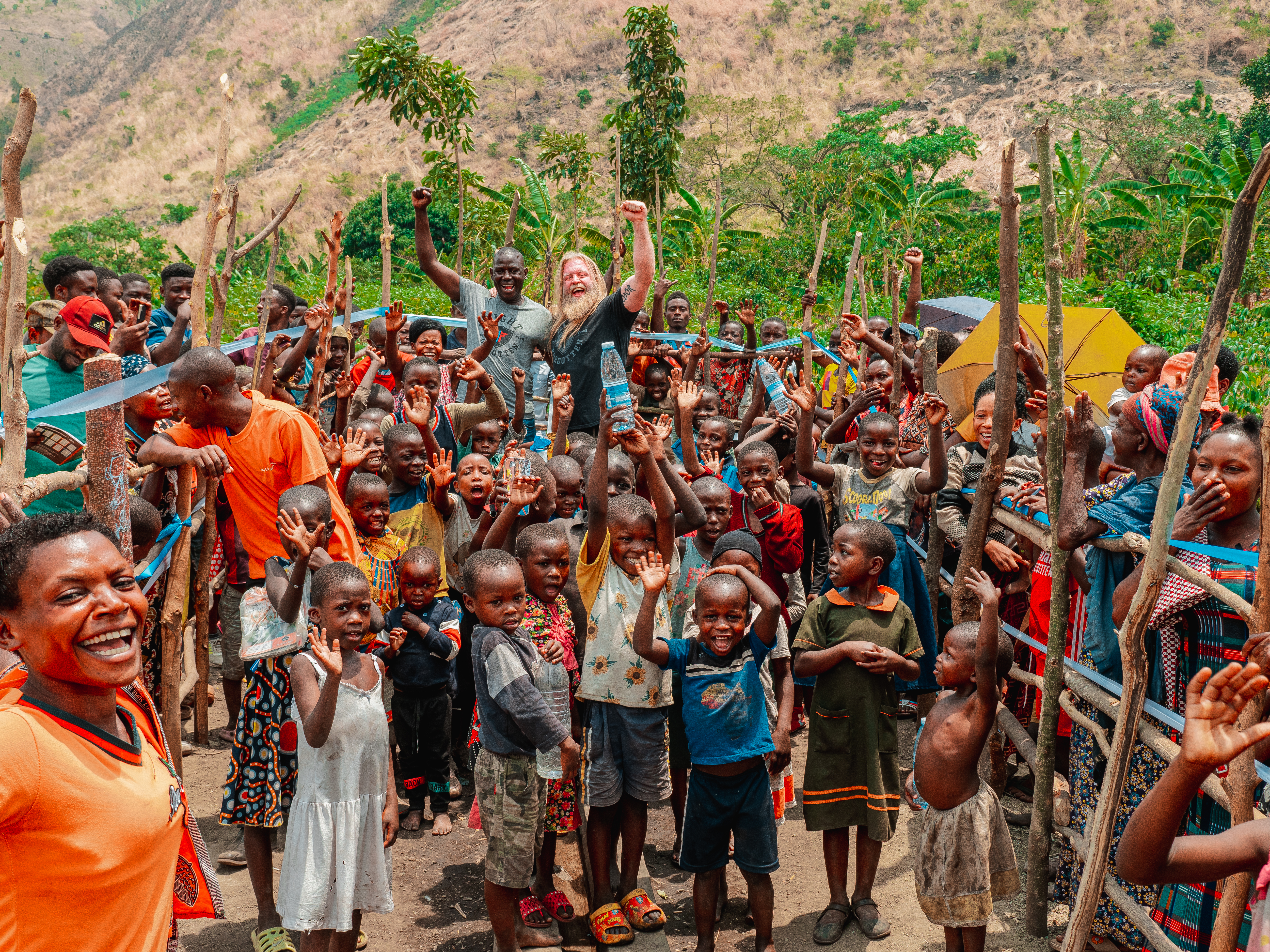 A large group of Mbuti pygmy of East Africa celebrating in their village with nonprofit founder.