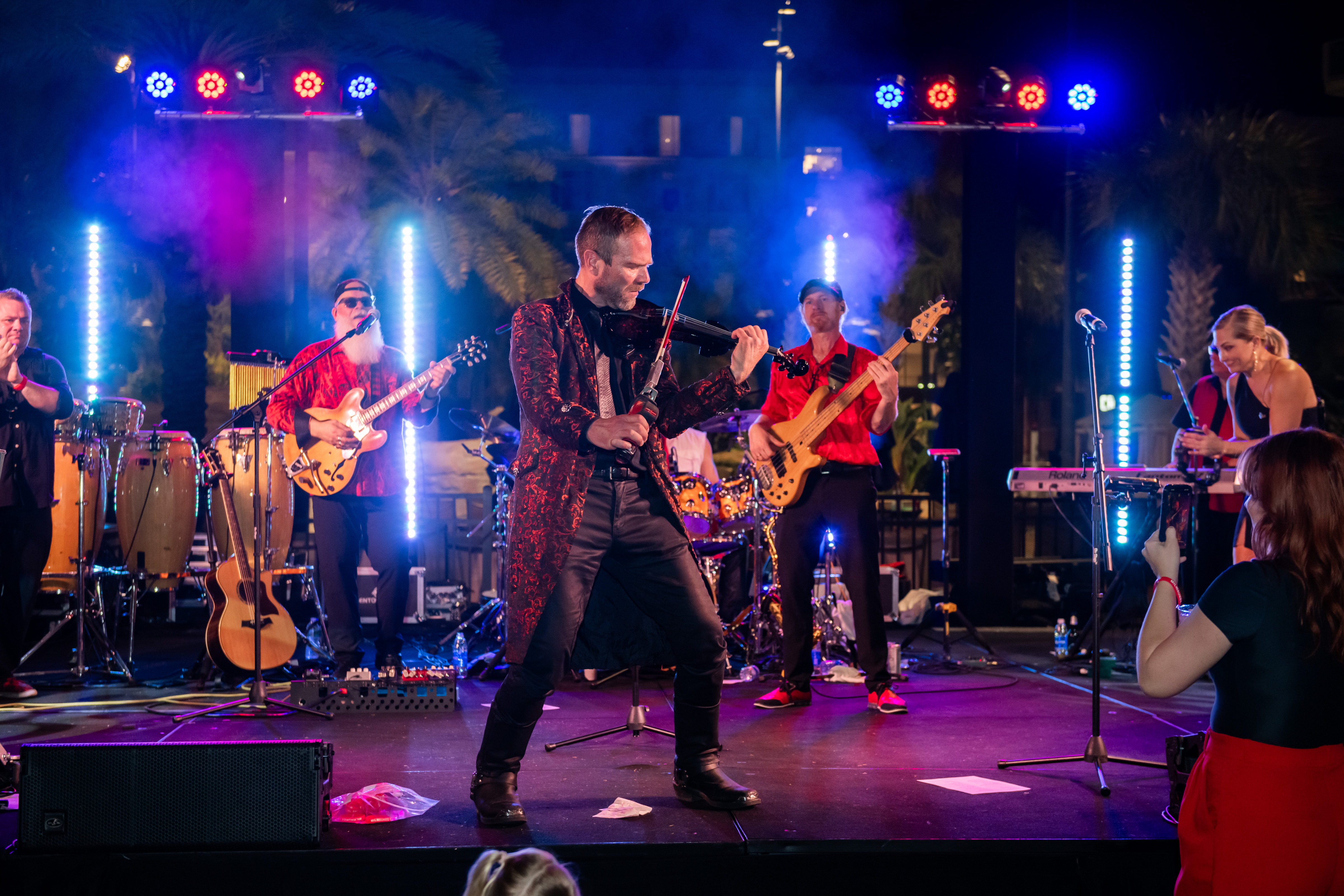 a man on stage playing an electric violin