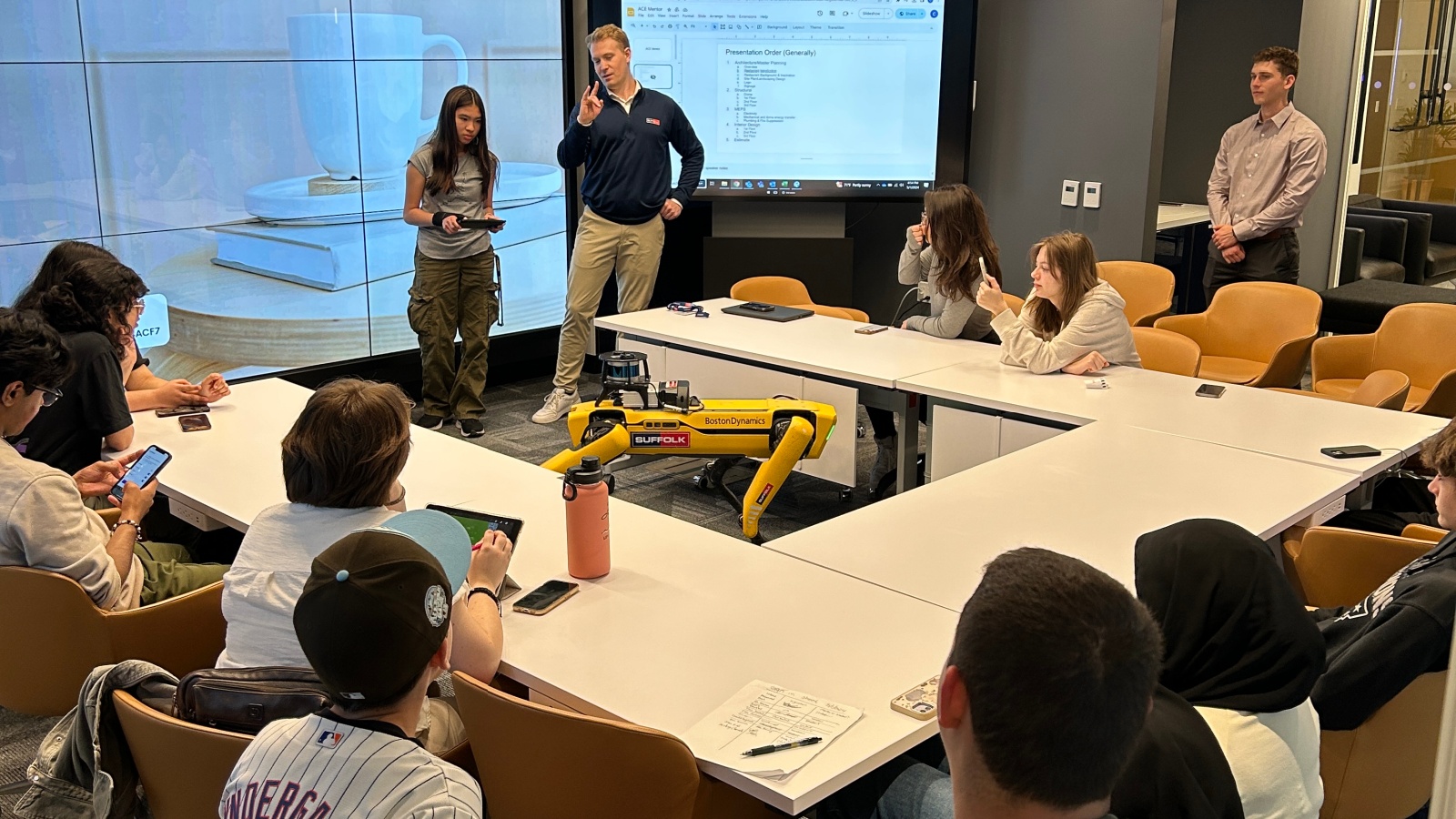 Spot the Robot Dog is demonstrated in front of a group of ACE mentor students at Suffolk's New York office