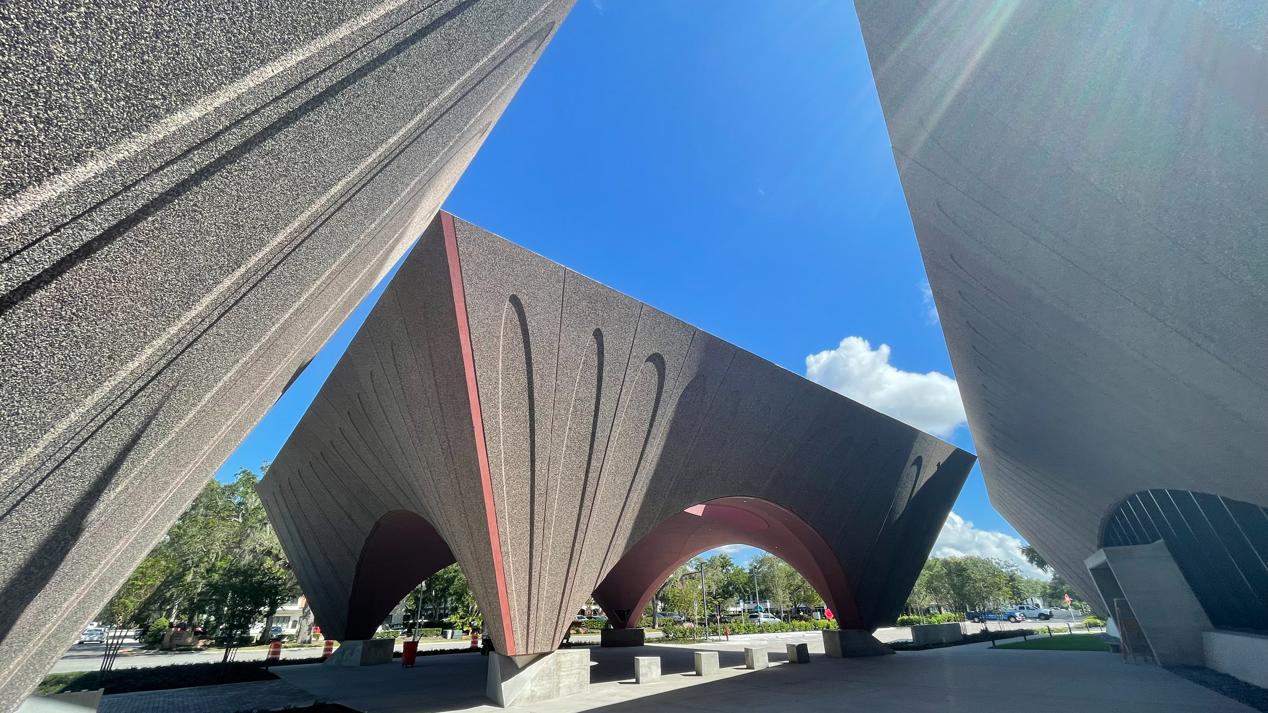 a building-size stone sculpture with carved archways on each side