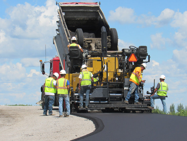 Construction workers from R.J. Zavoral and Sons doing construction on a road.
