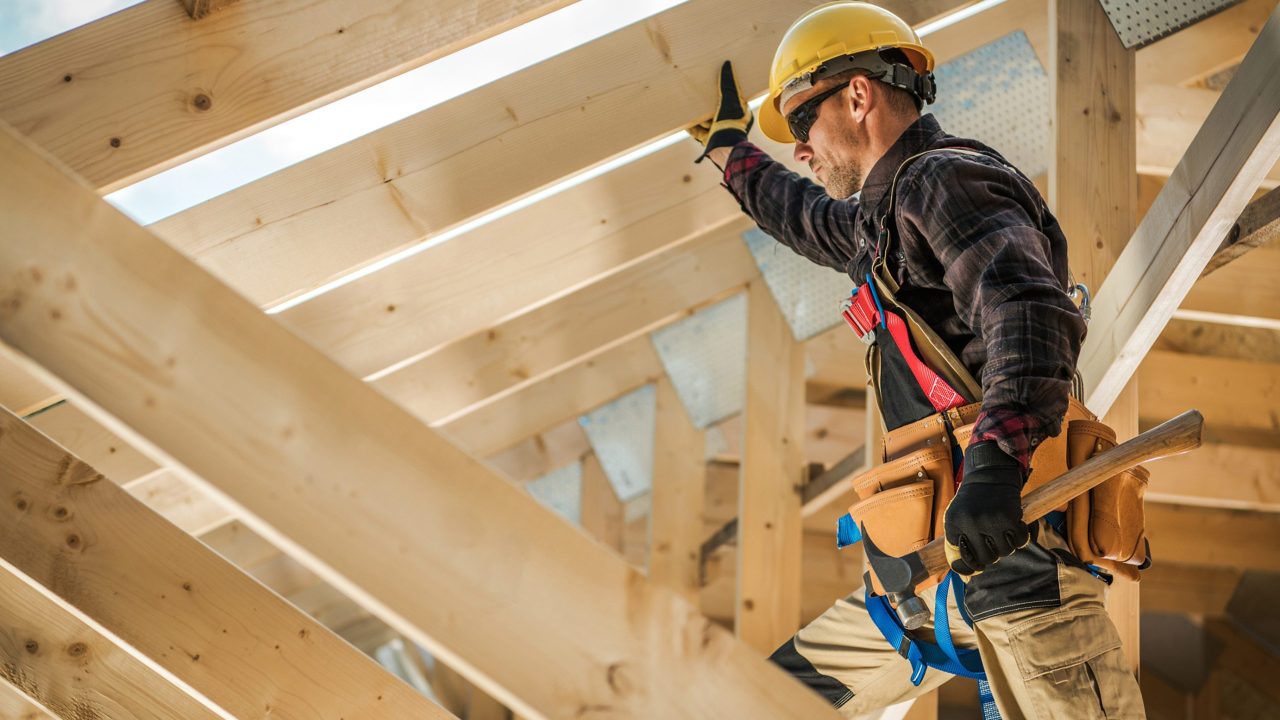 A construction worker building a wooden structure