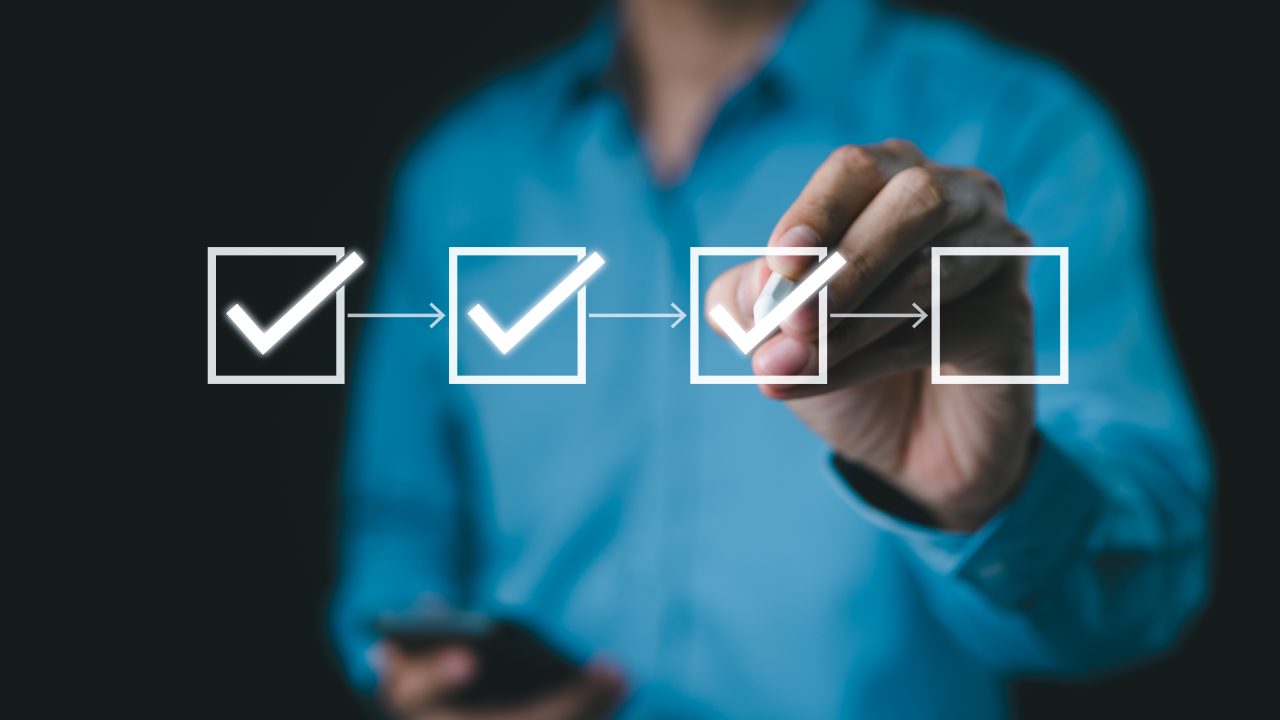 A man checking off tasks on a checklist.