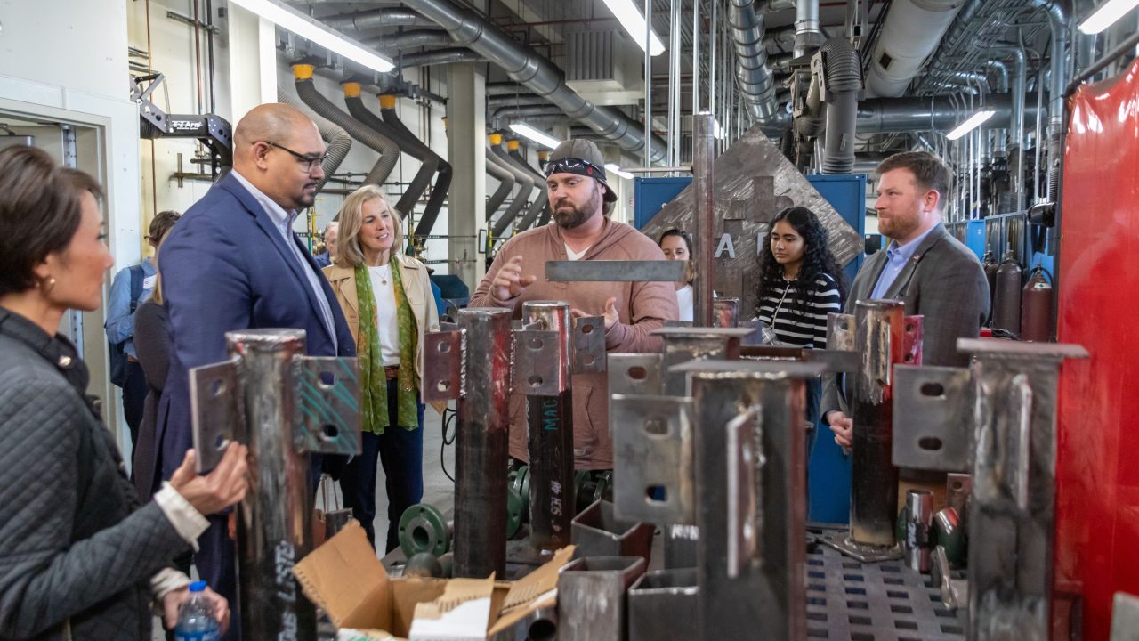 Employees at Johnson Controls talking to community college students.