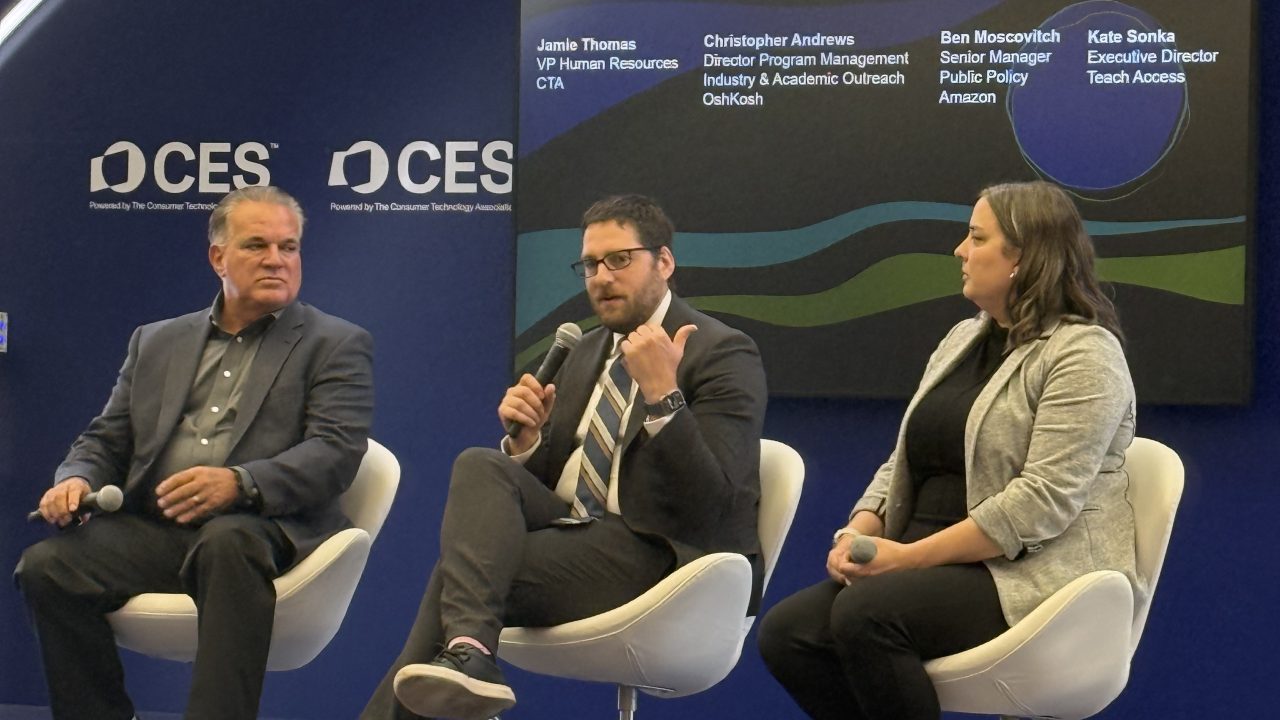 Three panelist talking on stage