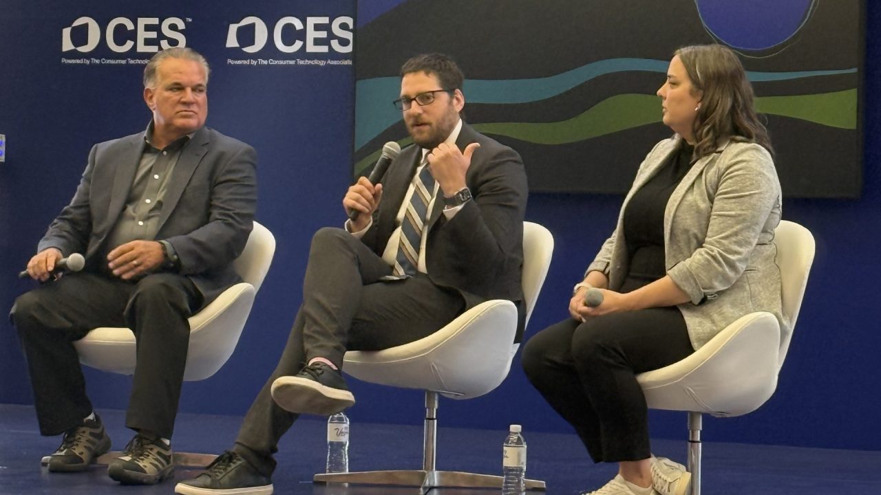 Three panelist talking on stage