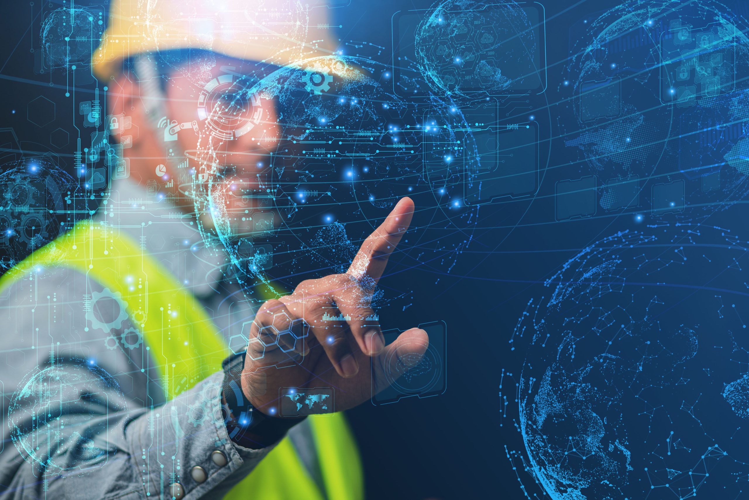 a construction worker touching a holographic projection of the earth and other graphs.