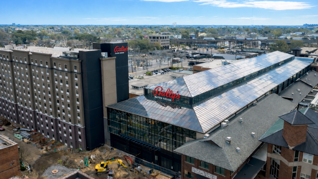 Aerial view of Bally's Baton Rouge Hotel and Casino showing the hotel tower, glass-roofed casino structure, and surrounding construction site.