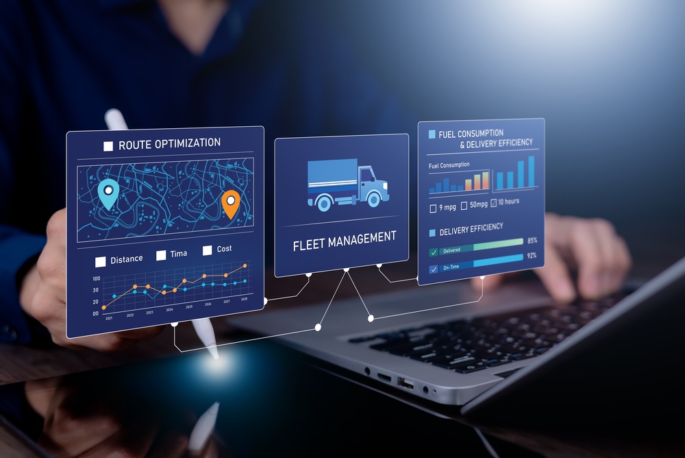 A person using a laptop and stylus with digital dashboards displayed above showing route optimization, fleet management, and fuel consumption and delivery efficiency data.