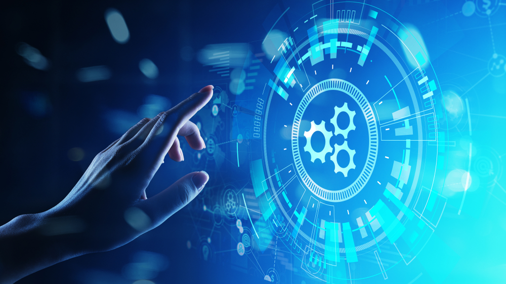 A hand touching a glowing digital interface with gear icons, representing automation.